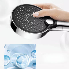 Close-up of handheld shower head in bathroom