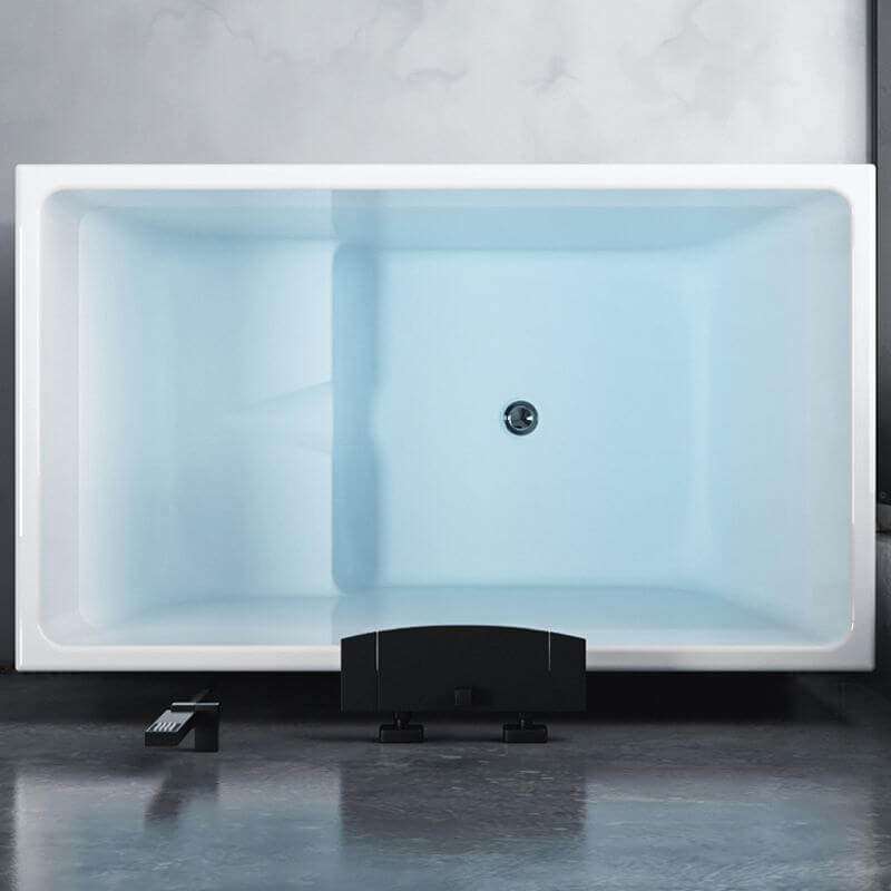 Freestanding soaking tub positioned against wall