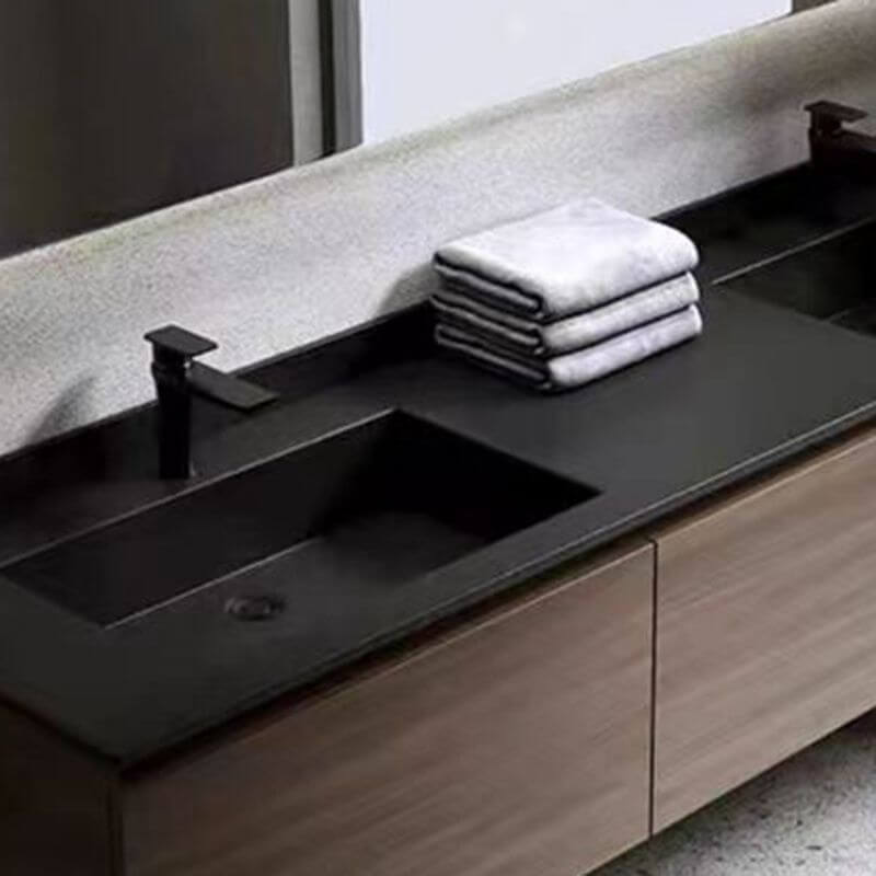 Brown wooden base bathroom vanity with black countertop