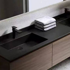 Brown wooden base bathroom vanity with black countertop