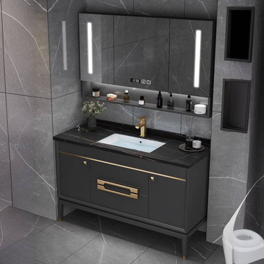 Free-standing bathroom vanity with black stone countertop