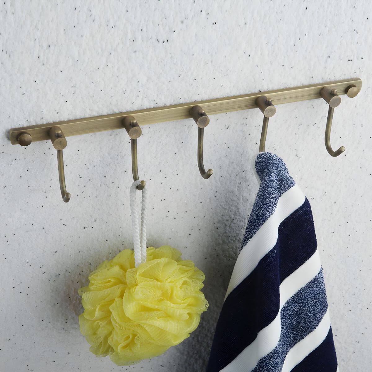 Elegant gold towel hooks mounted on wall