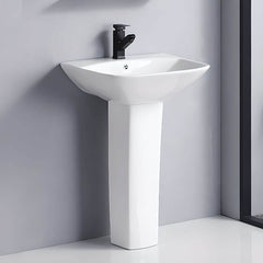 White ceramic U-shaped pedestal sink in modern bathroom