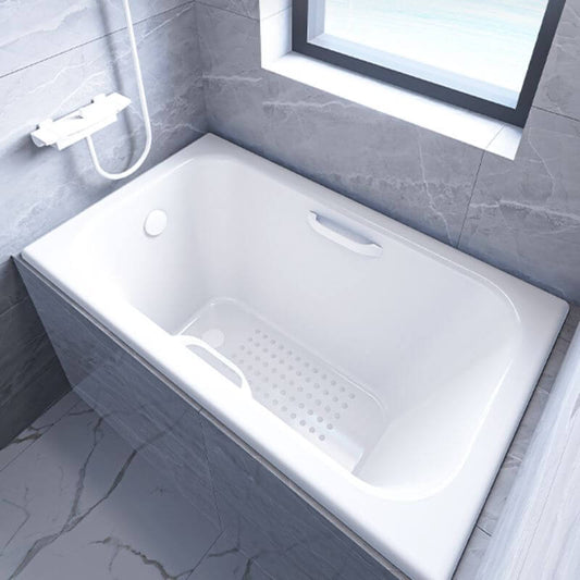 White cast iron rectangular drop-in bathtub with handle, back-to-wall design, and silver disc faucet